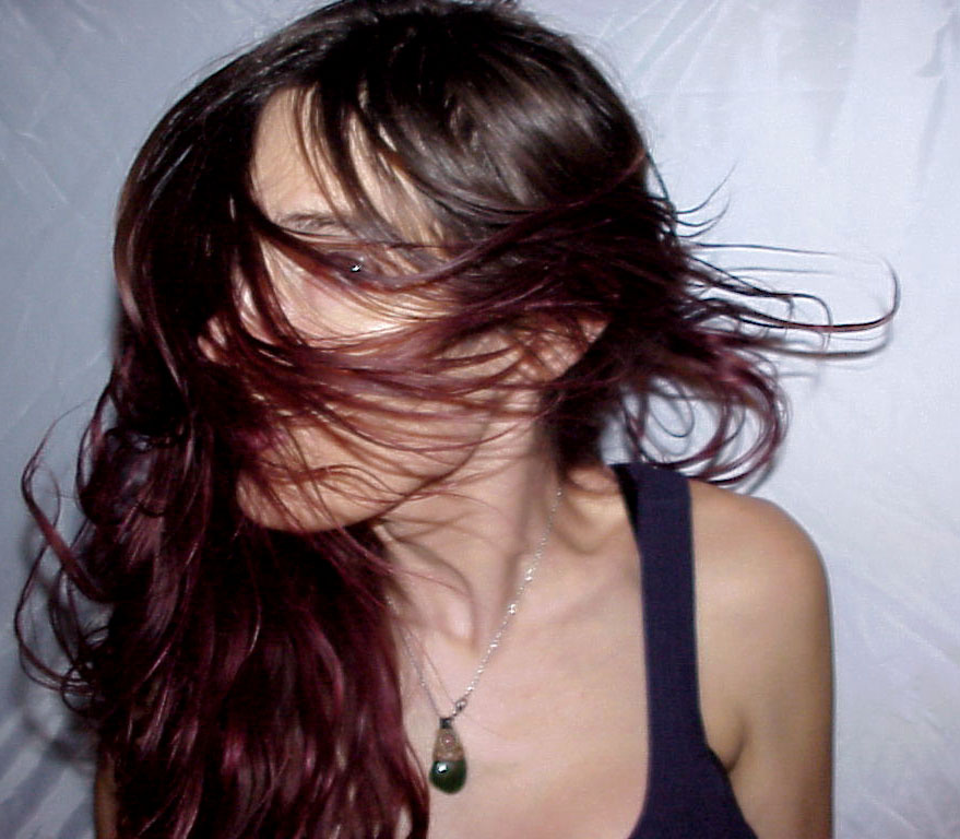 a woman with her hair in a whirlwind around her